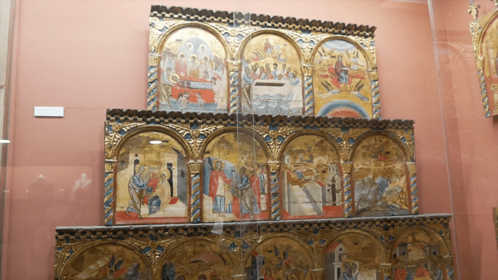 a group of paintings on a shelf