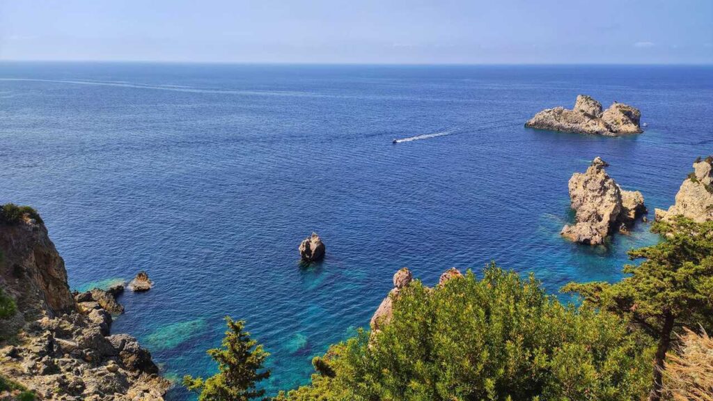 a body of water with rocks and trees